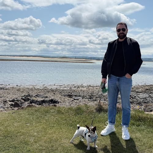 Cristi Glavan with his dog on the beach